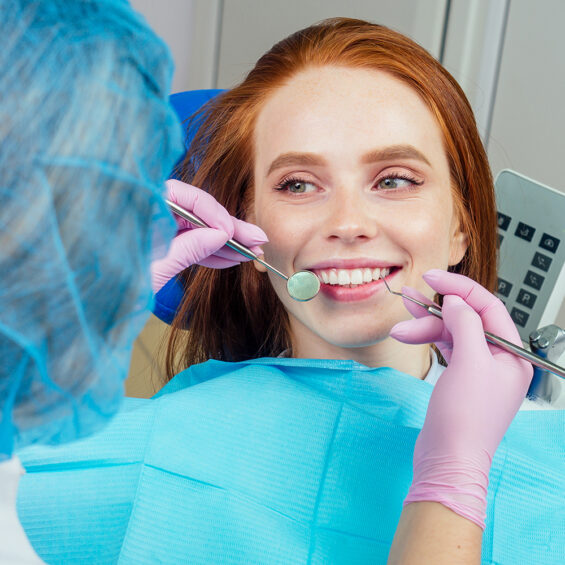 Dental drilling procedure and check up on beautiful teeth and open mouth.